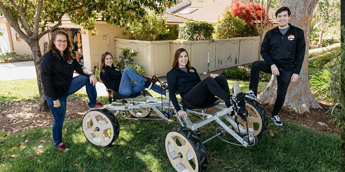 Students posing with the rover